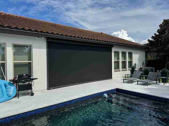 Custom Retractable Screens in Orlando, FL installed on an outdoor patio for sun protection
